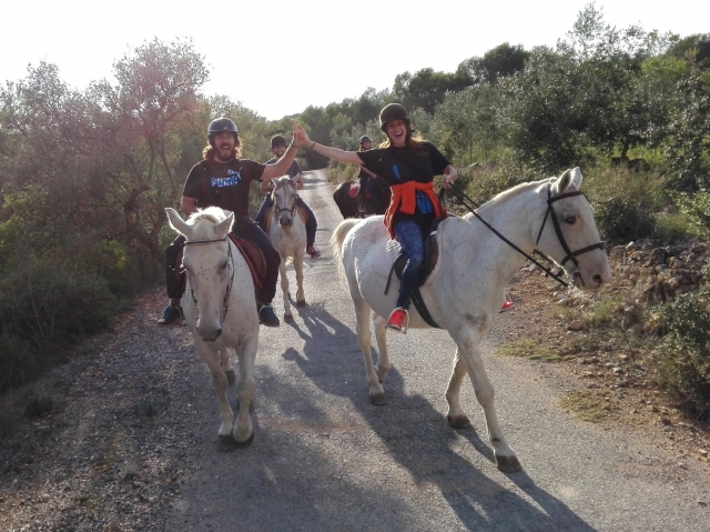 Dandose la mano a caballo
